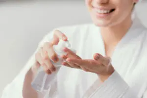 woman using white face cream